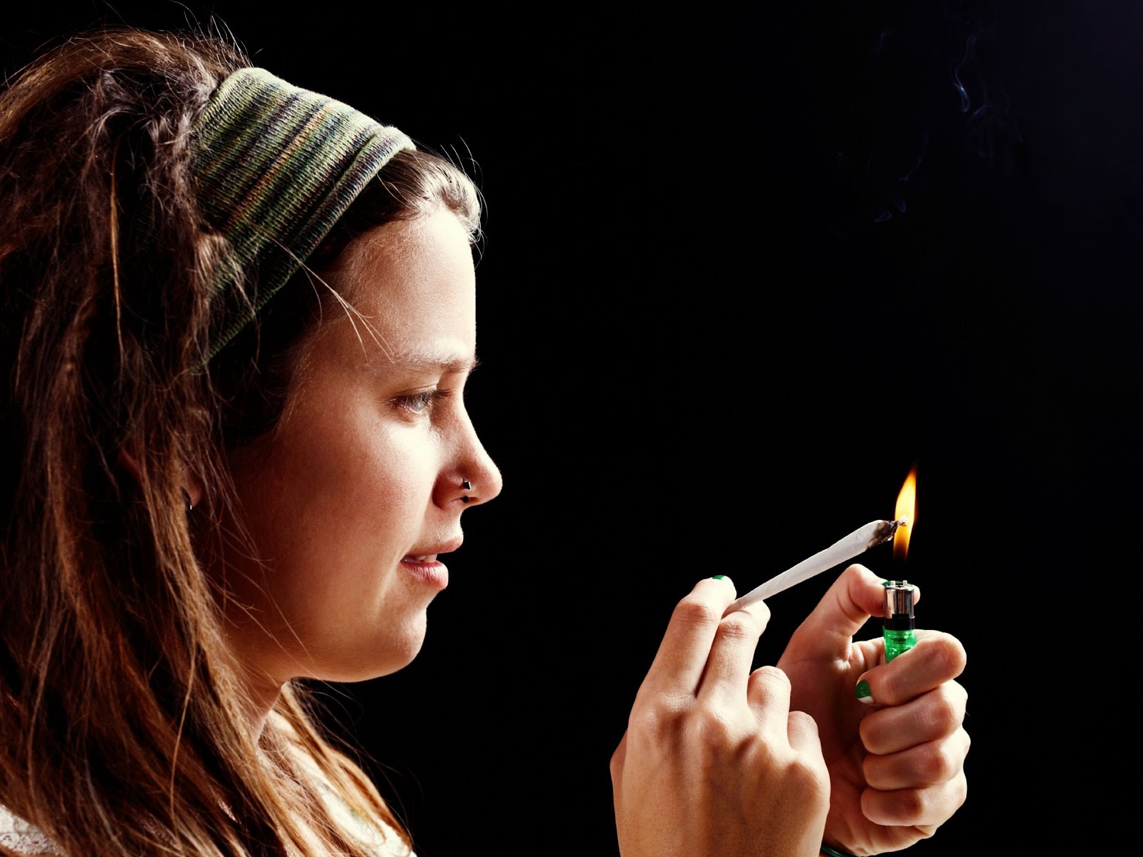 A woman suffering from cannabis addiction prepares to smoke weed due to withdrawal symptoms.
